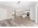 Open-concept living room and kitchen with modern finishes and gray plank flooring at 4444 Sw 118 Ter, Ocala, FL 34481
