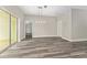 Open living area showcasing modern light fixture, and wood-look flooring at 4444 Sw 118 Ter, Ocala, FL 34481