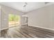 Bright, open living area features wood-look floors, modern lighting, and a sliding glass door at 4444 Sw 118 Ter, Ocala, FL 34481