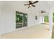 Covered patio with ceiling fans and sliding glass doors leading to the home's interior at 4444 Sw 118 Ter, Ocala, FL 34481