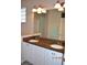 Bright bathroom with double sinks, granite countertop, and a large mirror at 8345 Sw 82Nd Loop, Ocala, FL 34481