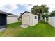 White shed with wooden doors in a grassy backyard at 352 Marion Oaks Ln, Ocala, FL 34473