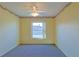 Empty bedroom featuring a ceiling fan and large window at 352 Marion Oaks Ln, Ocala, FL 34473