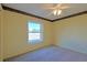 Well lit bedroom with carpet flooring and a window at 352 Marion Oaks Ln, Ocala, FL 34473