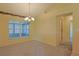 Dining room with chandelier, carpet flooring and view to the lanai at 352 Marion Oaks Ln, Ocala, FL 34473