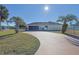 House exterior boasts a curved driveway and palm trees at 352 Marion Oaks Ln, Ocala, FL 34473