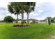 Landscaped front yard with lush green grass and mature palm trees at 352 Marion Oaks Ln, Ocala, FL 34473