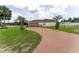 House exterior showcasing a garage with a screened enclosure and a long driveway at 352 Marion Oaks Ln, Ocala, FL 34473