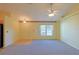 Bright living room featuring carpeted floors and a ceiling fan at 352 Marion Oaks Ln, Ocala, FL 34473