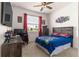 Comfortable bedroom with themed decor, a ceiling fan, and natural light from the window at 8996 Sw 49Th Cir, Ocala, FL 34476