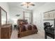 Comfortable bedroom featuring carpet, a ceiling fan, and coordinated furniture at 8996 Sw 49Th Cir, Ocala, FL 34476