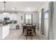 Dining room with natural light, dark wood table, and adjacent kitchen view at 8996 Sw 49Th Cir, Ocala, FL 34476