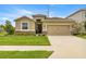 Charming single-Gathering home with a well-manicured lawn, a two-car garage, and stone accents at 8996 Sw 49Th Cir, Ocala, FL 34476