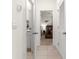 Hallway view showcasing a bathroom and bedroom with neutral paint and tile flooring at 8996 Sw 49Th Cir, Ocala, FL 34476