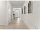 Inviting hallway featuring tile flooring and decorative wall art leading to the front door at 8996 Sw 49Th Cir, Ocala, FL 34476