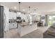 Modern kitchen featuring white cabinets, granite countertops, and an island with pendant lighting at 8996 Sw 49Th Cir, Ocala, FL 34476