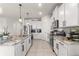 Modern kitchen featuring white cabinetry, granite countertops, and stainless steel appliances at 8996 Sw 49Th Cir, Ocala, FL 34476