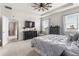 Bright and airy main bedroom with tray ceilings, ceiling fan, and ample natural light at 8996 Sw 49Th Cir, Ocala, FL 34476