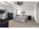 Spacious main bedroom with tray ceiling, ceiling fan, neutral colors, and plenty of natural light at 8996 Sw 49Th Cir, Ocala, FL 34476