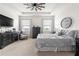 Main bedroom featuring a tray ceiling, ceiling fan, and abundant natural light at 8996 Sw 49Th Cir, Ocala, FL 34476