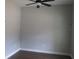 Bedroom features a ceiling fan, light-colored walls, wood floors, and natural light at 13083 Sw 61St Place Rd, Ocala, FL 34481