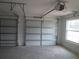 Spacious garage with two doors, automatic opener, and natural light from a window at 13083 Sw 61St Place Rd, Ocala, FL 34481