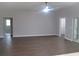 Open-concept living room with wood flooring and neutral paint at 13083 Sw 61St Place Rd, Ocala, FL 34481