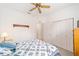 Comfortable bedroom with a ceiling fan and double doors to closet at 9500 Sw 93Rd Loop, Ocala, FL 34481