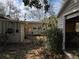 Backyard view showing home, shed, and landscaping at 1105 Ne 45 Pl, Ocala, FL 34479