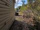 Backyard with shed and leaf covered ground at 1105 Ne 45 Pl, Ocala, FL 34479