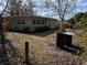 Large backyard with mature trees and a storage shed at 1105 Ne 45 Pl, Ocala, FL 34479