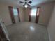 Spacious bedroom with two windows and neutral decor at 1105 Ne 45 Pl, Ocala, FL 34479