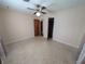 Well-lit bedroom with ceiling fan and large closet at 1105 Ne 45 Pl, Ocala, FL 34479