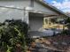 Covered carport with concrete slab and mature landscaping at 1105 Ne 45 Pl, Ocala, FL 34479