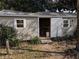 Tan colored shed with double doors and windows at 1105 Ne 45 Pl, Ocala, FL 34479