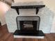 White brick fireplace with black mantel and hearth at 1105 Ne 45 Pl, Ocala, FL 34479