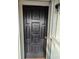 Black front door with an embossed design at 1105 Ne 45 Pl, Ocala, FL 34479