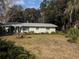 Charming ranch home with a large yard and mature trees at 1105 Ne 45 Pl, Ocala, FL 34479