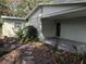 View of house exterior showcasing covered porch and landscaping at 1105 Ne 45 Pl, Ocala, FL 34479