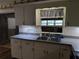 White kitchen cabinets, double sink, and updated countertops at 1105 Ne 45 Pl, Ocala, FL 34479