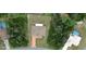 Aerial view showcasing the property with surrounding trees, neighboring pool, and fenced-in yard at 15747 Sw 47Th Avenue Rd, Ocala, FL 34473