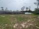 Spacious backyard with a mix of grass and sand, surrounded by a wooden fence at 15747 Sw 47Th Avenue Rd, Ocala, FL 34473