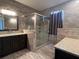 Granite countertops, dark cabinetry and walk-in shower in remodeled bathroom at 15747 Sw 47Th Avenue Rd, Ocala, FL 34473