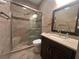 Modern bathroom with tiled shower, glass door, and granite-topped vanity at 15747 Sw 47Th Avenue Rd, Ocala, FL 34473