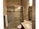 Bathroom with granite counters and tiled shower with glass door and grab bar at 15747 Sw 47Th Avenue Rd, Ocala, FL 34473
