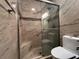 Tiled bathroom featuring a step-in shower with a glass door and decorative tile accents at 15747 Sw 47Th Avenue Rd, Ocala, FL 34473