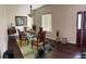 Bright dining room featuring a modern chandelier and a glass top table for entertaining at 15747 Sw 47Th Avenue Rd, Ocala, FL 34473