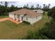 Charming single-Gathering home featuring stucco siding, a brown shingle roof, and a spacious front yard at 15747 Sw 47Th Avenue Rd, Ocala, FL 34473