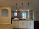 Open-concept kitchen with island, white cabinets, granite countertops, and modern appliances at 15747 Sw 47Th Avenue Rd, Ocala, FL 34473