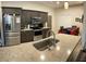 Updated kitchen featuring stainless steel appliances, granite countertops, and dark wood cabinets at 15747 Sw 47Th Avenue Rd, Ocala, FL 34473